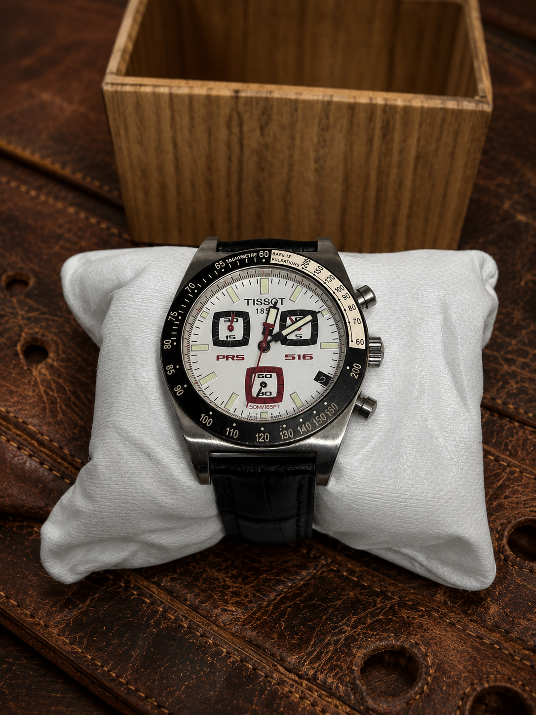 Tissot men's watch with white dial, stainless steel case, and elegant Swiss design